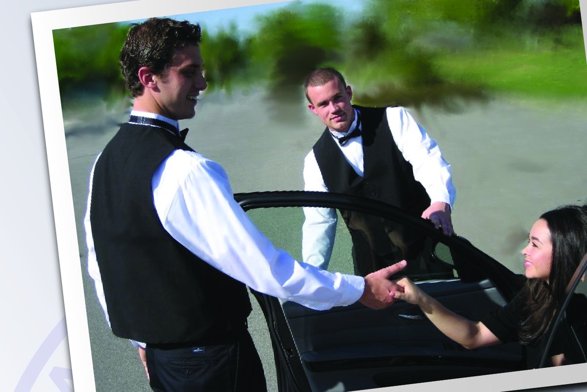 Valet attendant assisting a guest from a car